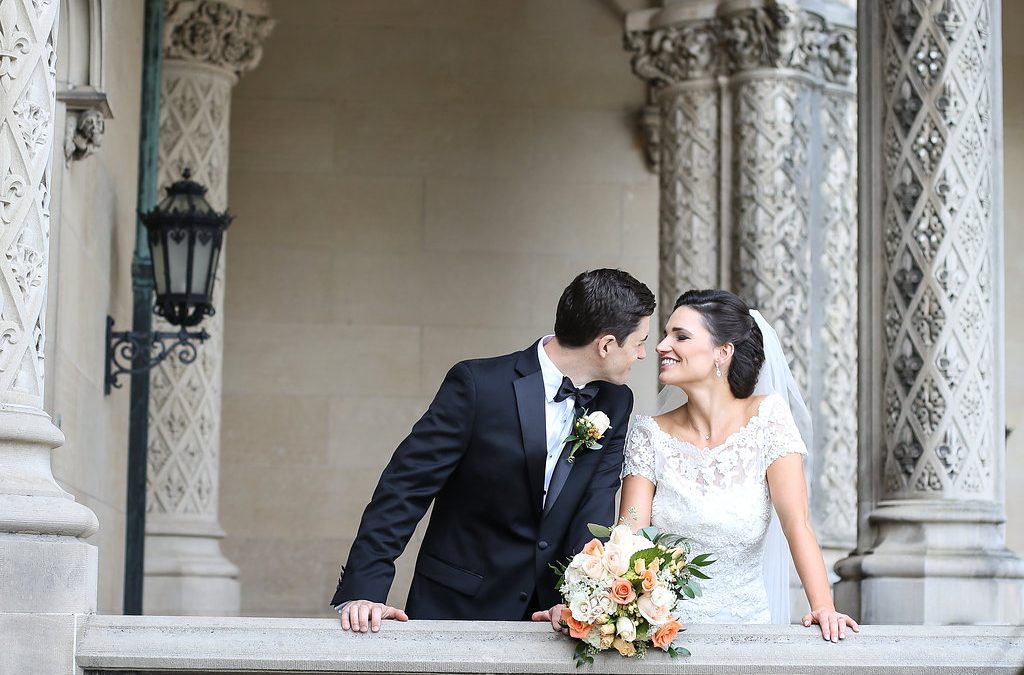Traditional bride and groom prepare to kiss on the colonnade of the Biltmore Estate.